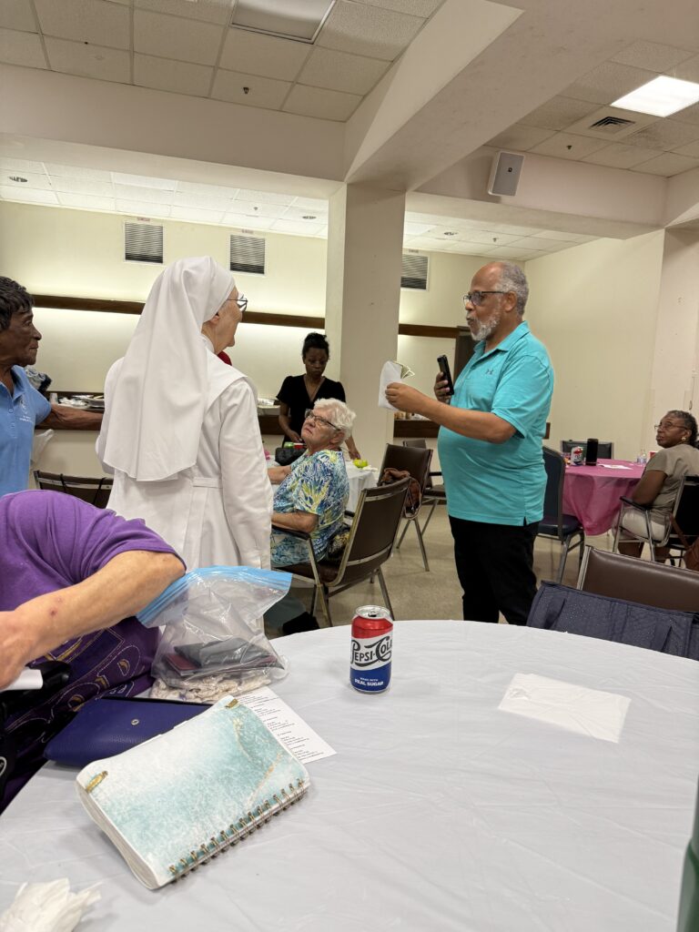 James Brightful presenting a donation to the Little Sisters of the Poor